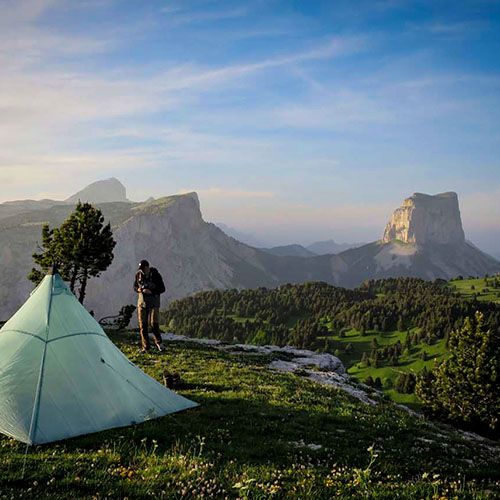 photo d'un randonneur et de sa toile de tente lors d'un séjour slow-itinérance en montagne